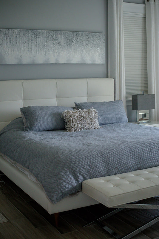 White bed with blue sheets