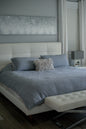 White bed with blue sheets